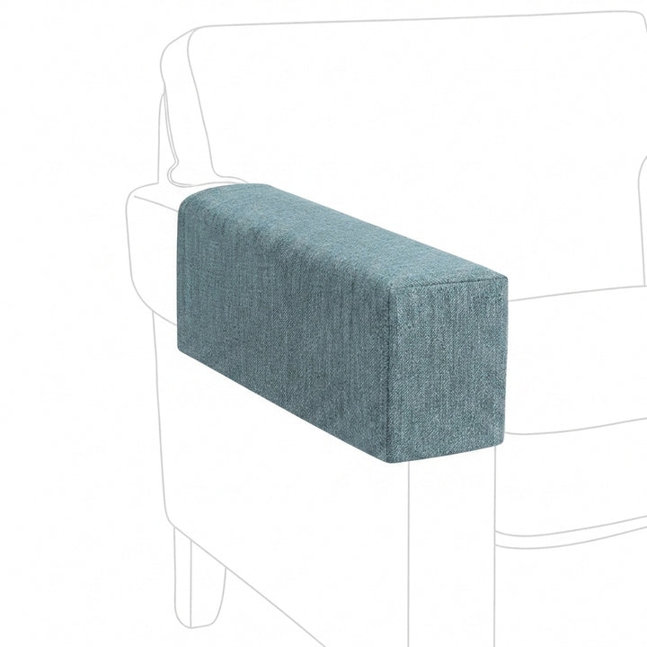 A rectangular upholstered armrest cushion in a textured slate blue fabric, shown fitted over the arm of a white armchair against a white background.