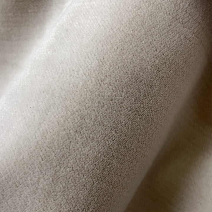 Close-up fabric swatch of Velvet Cream, a warm cream velvet with a short, dense pile