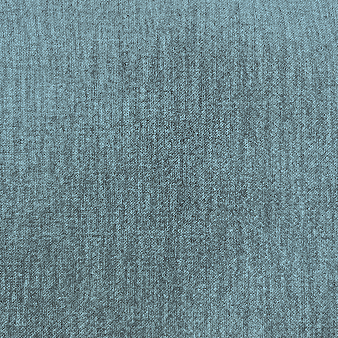 A close-up texture shot of a heathered blue-gray woven fabric, showing the fine knit pattern and subtle color variation.