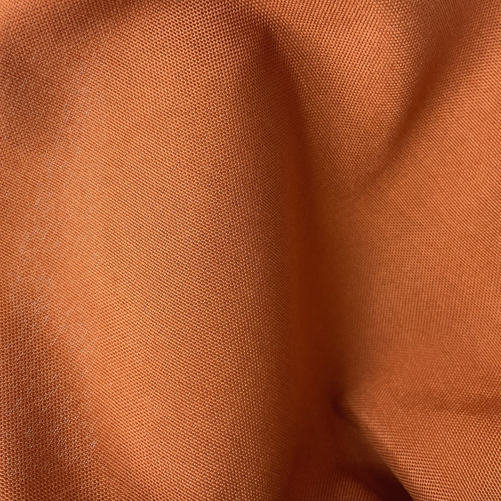 Close-up fabric swatch of Terracotta Sun Outdoor Performance, a solid warm terracotta indoor-outdoor performance weave