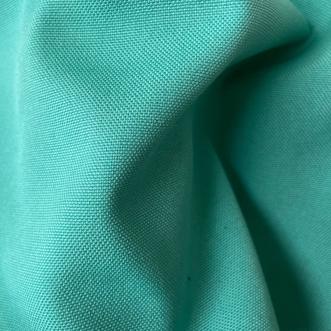 Close-up fabric swatch of Turquoise Outdoor Performance, a solid turquoise indoor-outdoor performance weave