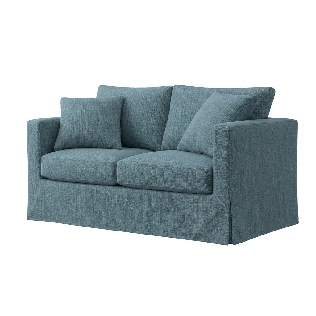 A two-seater loveseat sofa with a textured slate blue fabric slipcover and matching throw pillows, shown on a plain white background.