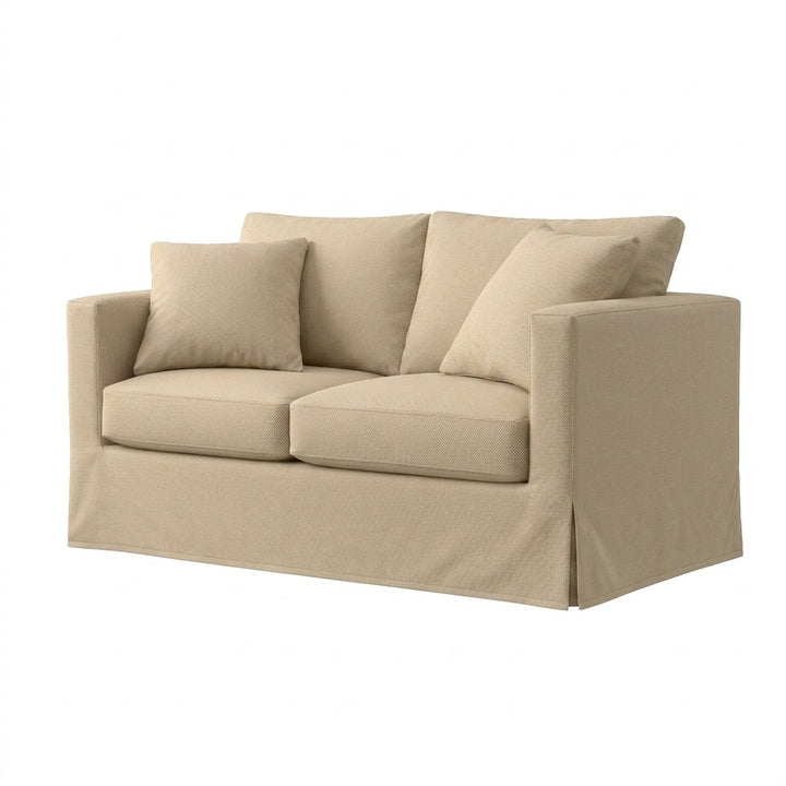 A beige slipcovered loveseat with two matching throw pillows, shown on a plain white background.